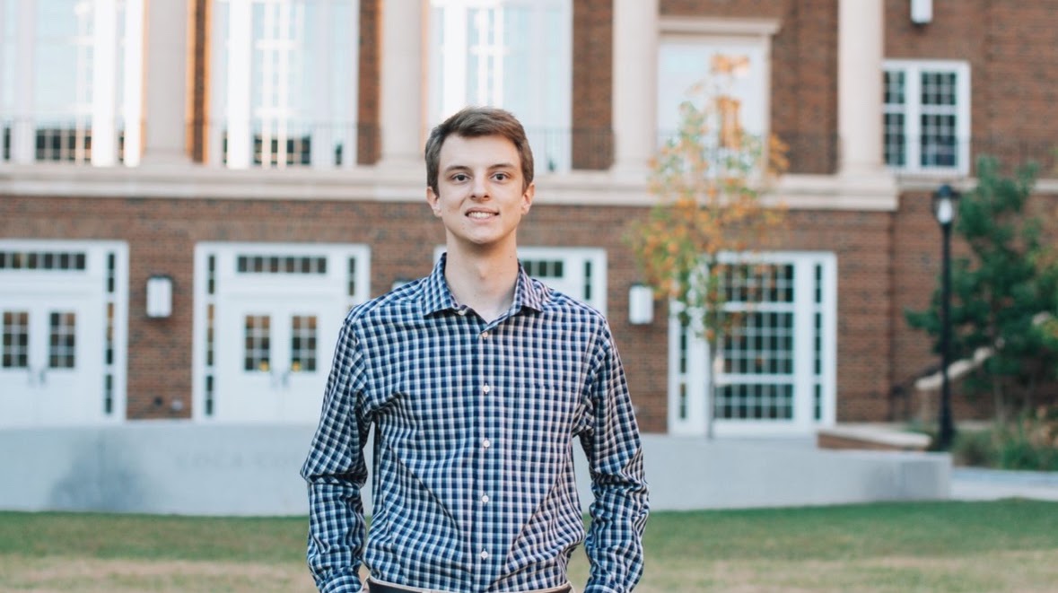 Cole Wittbrodt standing outside a university building